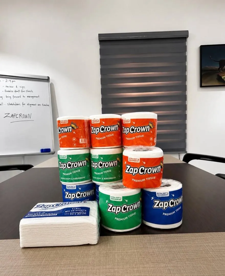 ZapCrown toilet tissue rolls in blue, green and orange packs with serviettes
